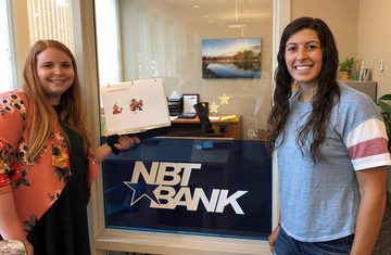 Hilary Dwyer and Beth Coppolecchia drop off materials at NBT Bank
